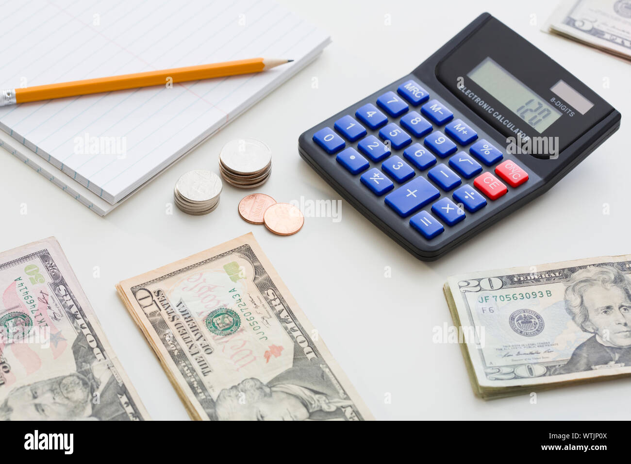 Calculator and US currency on desk Stock Photo