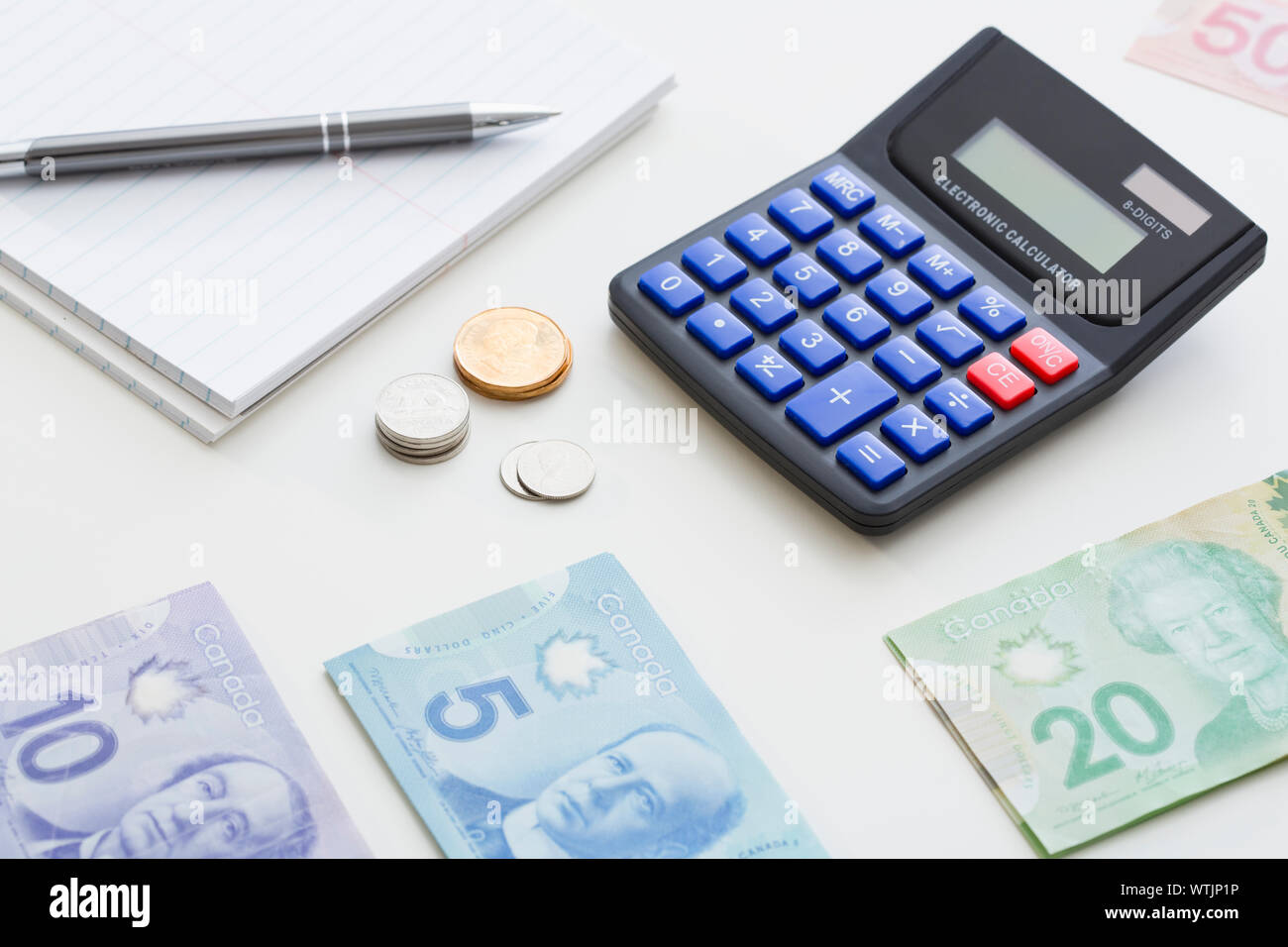 Calculator and Canadian currency on desk Stock Photo Alamy