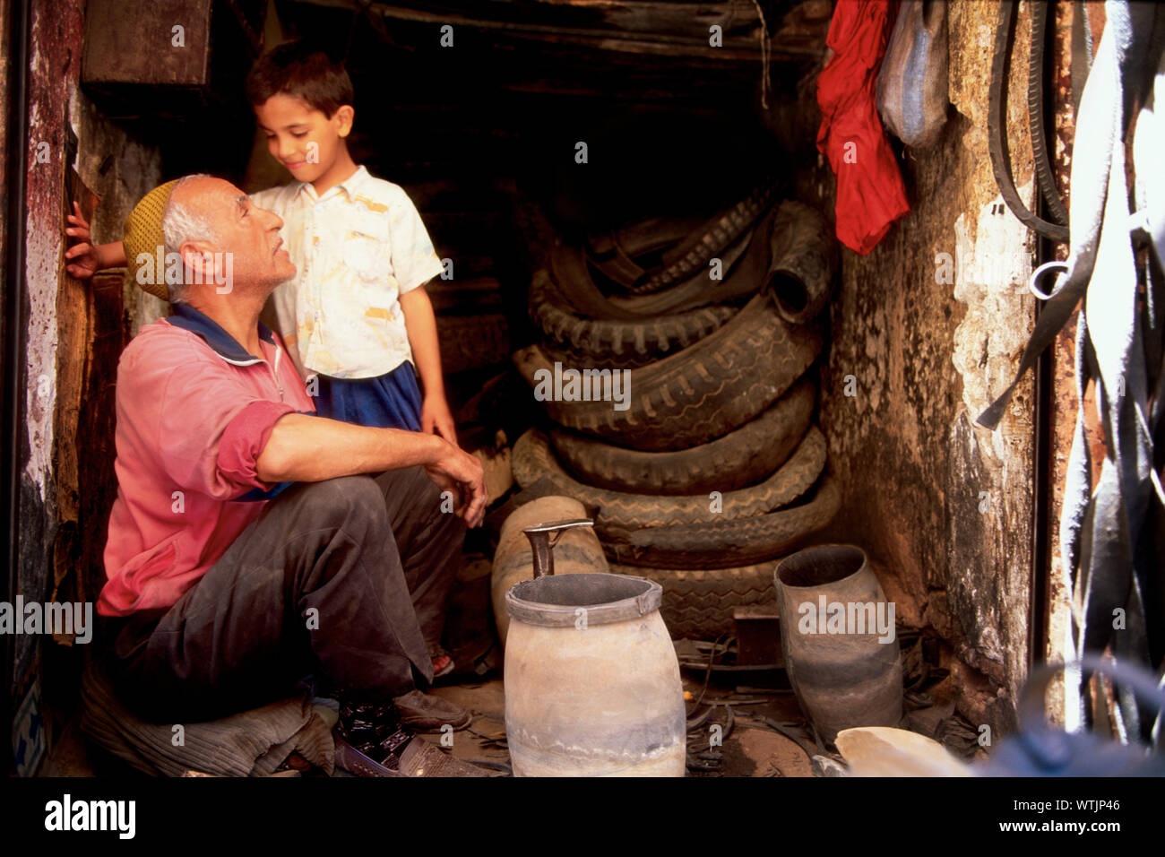 Grandfather and grandson in a repair shop. Stock Photo