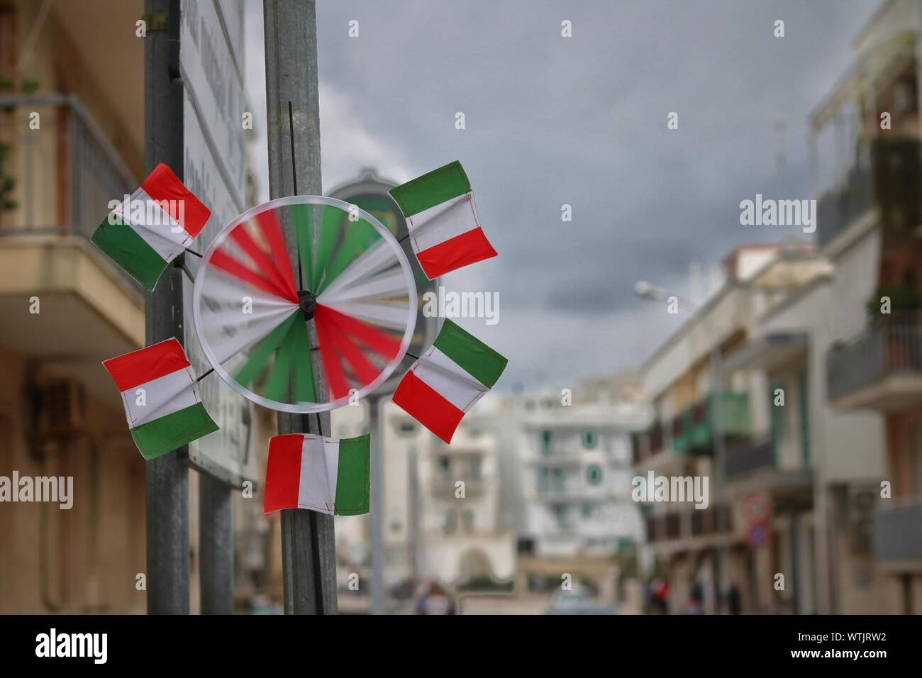 Italian Flag Pinwheel Toy On Pole In City Stock Photo