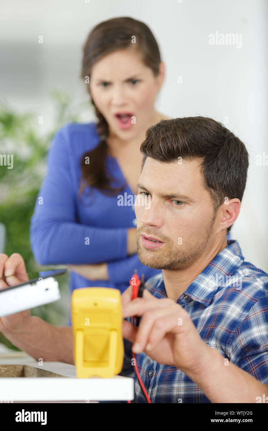 professional electrician troubleshooting an electric stove Stock Photo