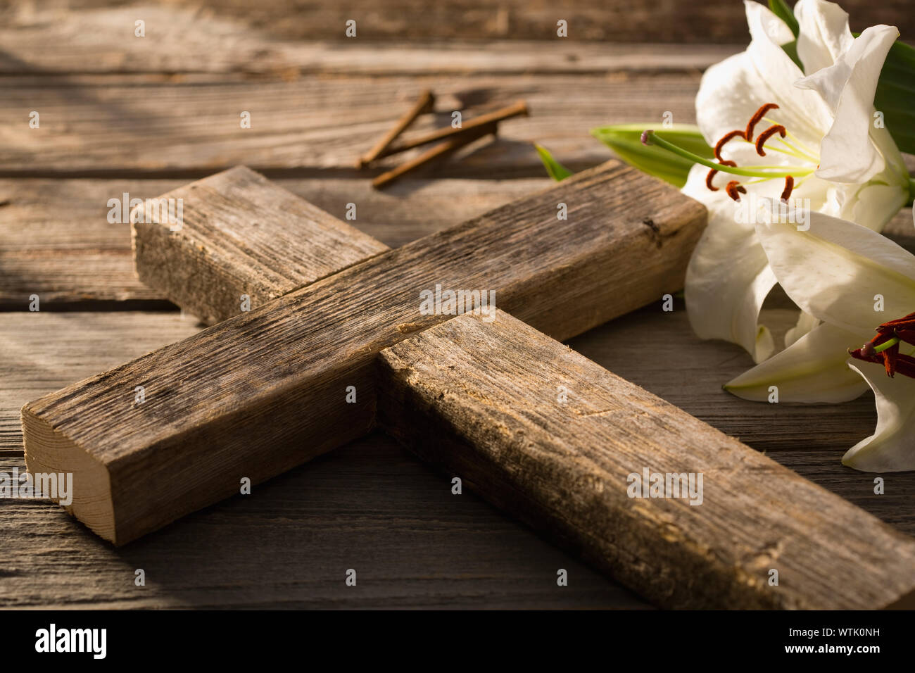 Close-up of wooden cross and white lily Stock Photo
