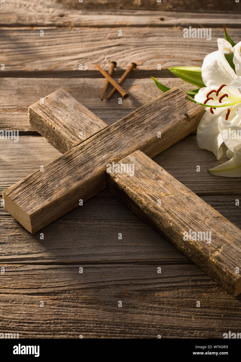 Close-up of wooden cross and white lily Stock Photo