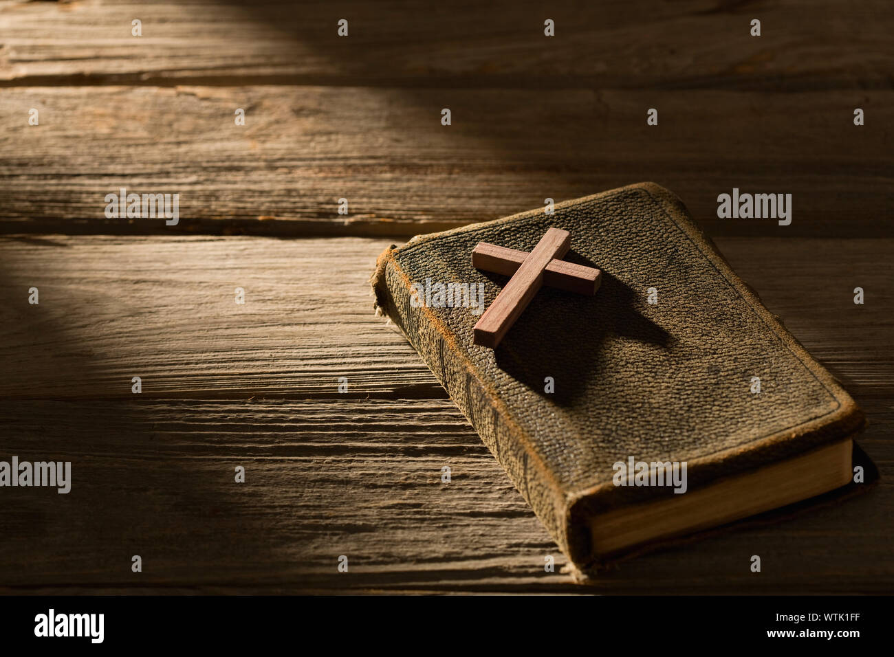 Studio shot of wooden cross and bible Stock Photo