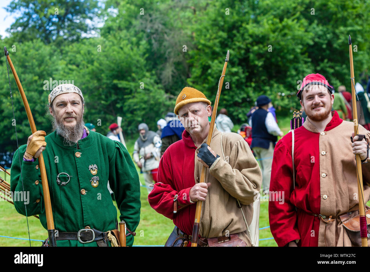 A group of men in medieval costume with participants at The Medieval Fayre. Stock Photo