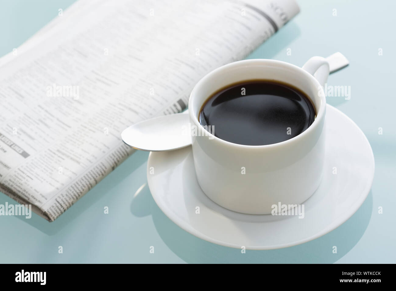 Coffee cup and newspaper Stock Photo - Alamy