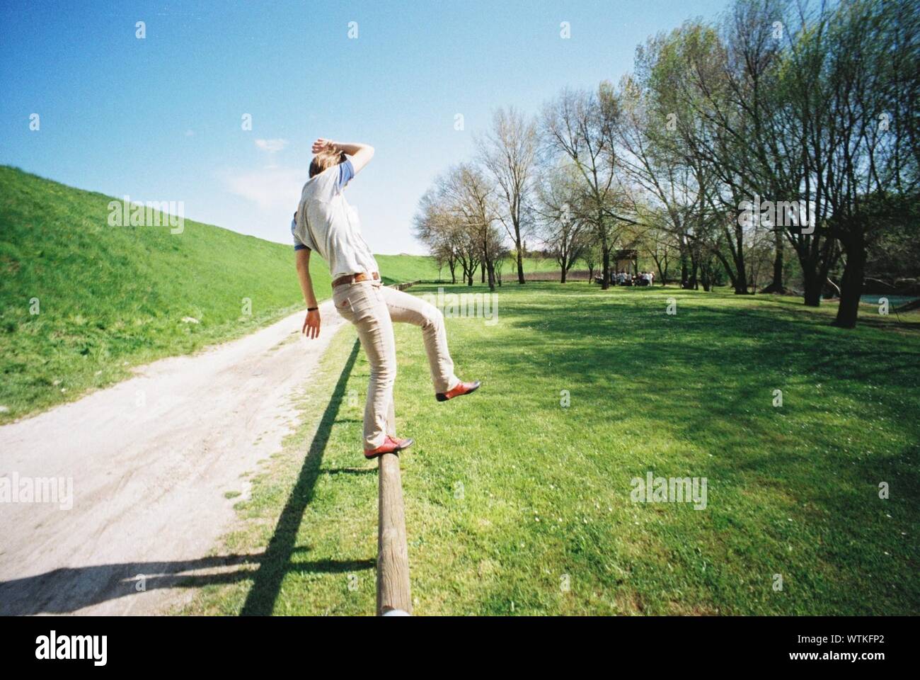 woman-standing-on-one-leg-on-rail-fence-stock-photo-alamy