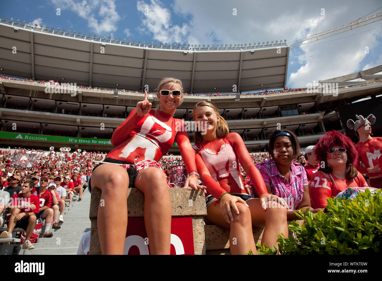 Most of the fans wear crimson and white with the name of the football team on their garments at University of Alabama, Tuscaloosa, Alabama Stock Photo