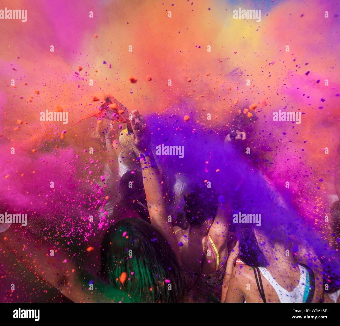 People Throwing Colorful Powder Paint During Holi Festival Stock Photo -  Alamy