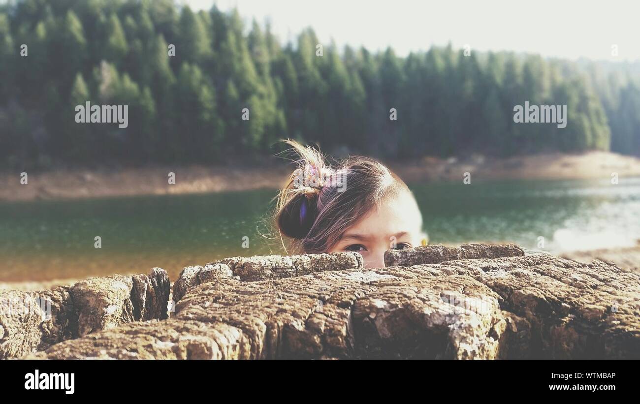 Portrait Of Girl Hiding Behind Wall Stock Photo Alamy