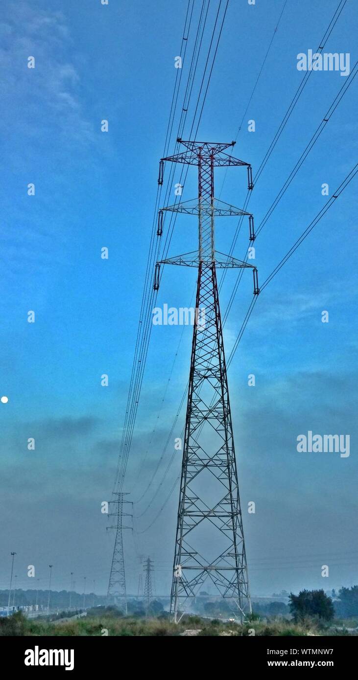 Electricity Pylon Against Blue Sky Stock Photo - Alamy