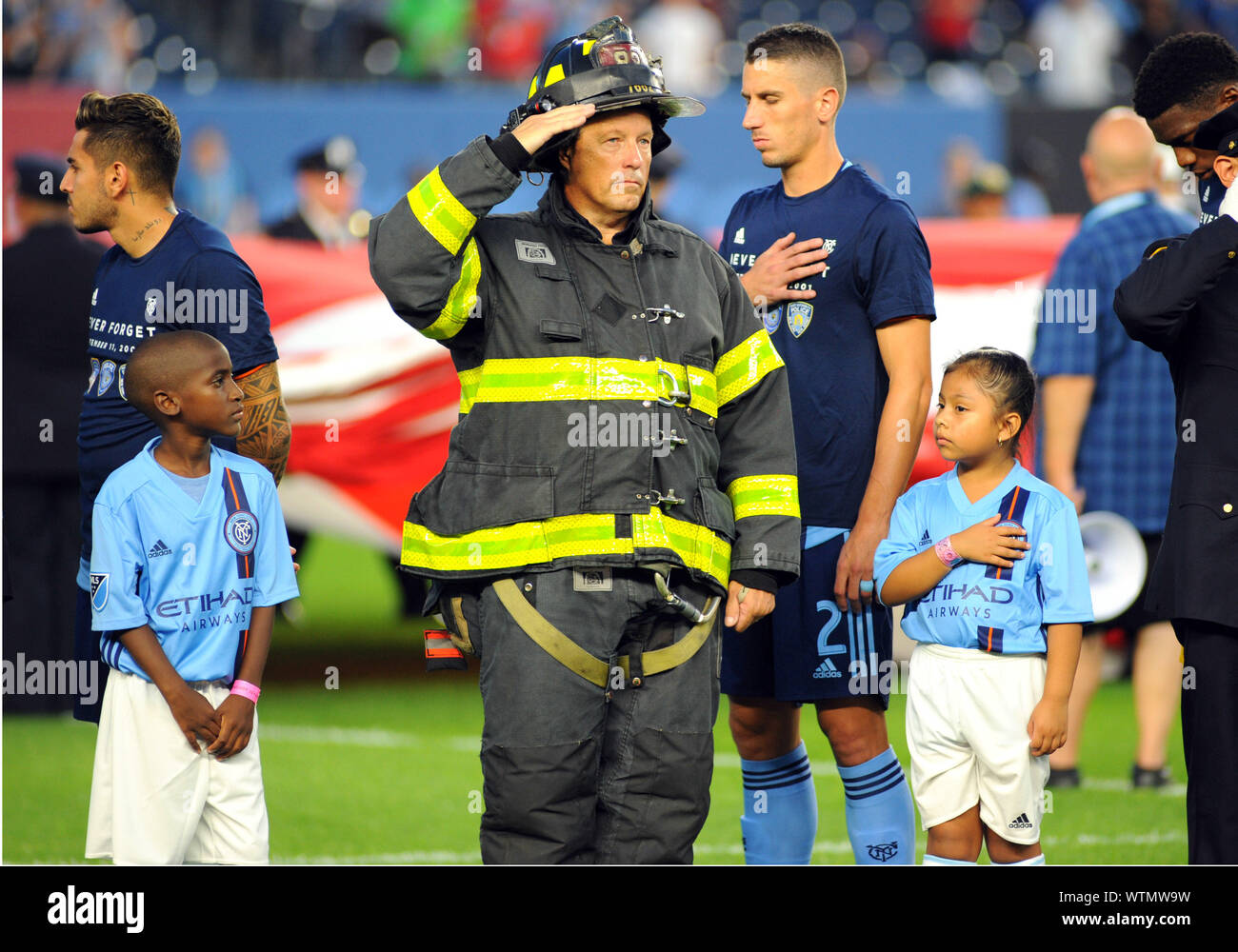 New York, NY, USA. 11th Sep, 2019. First Responders salute the flag before the NYCFC soccer game against Toronto FC at Yankee Stadium in New York, NY. Bennett Cohen/CSM/Alamy Live News Stock Photo