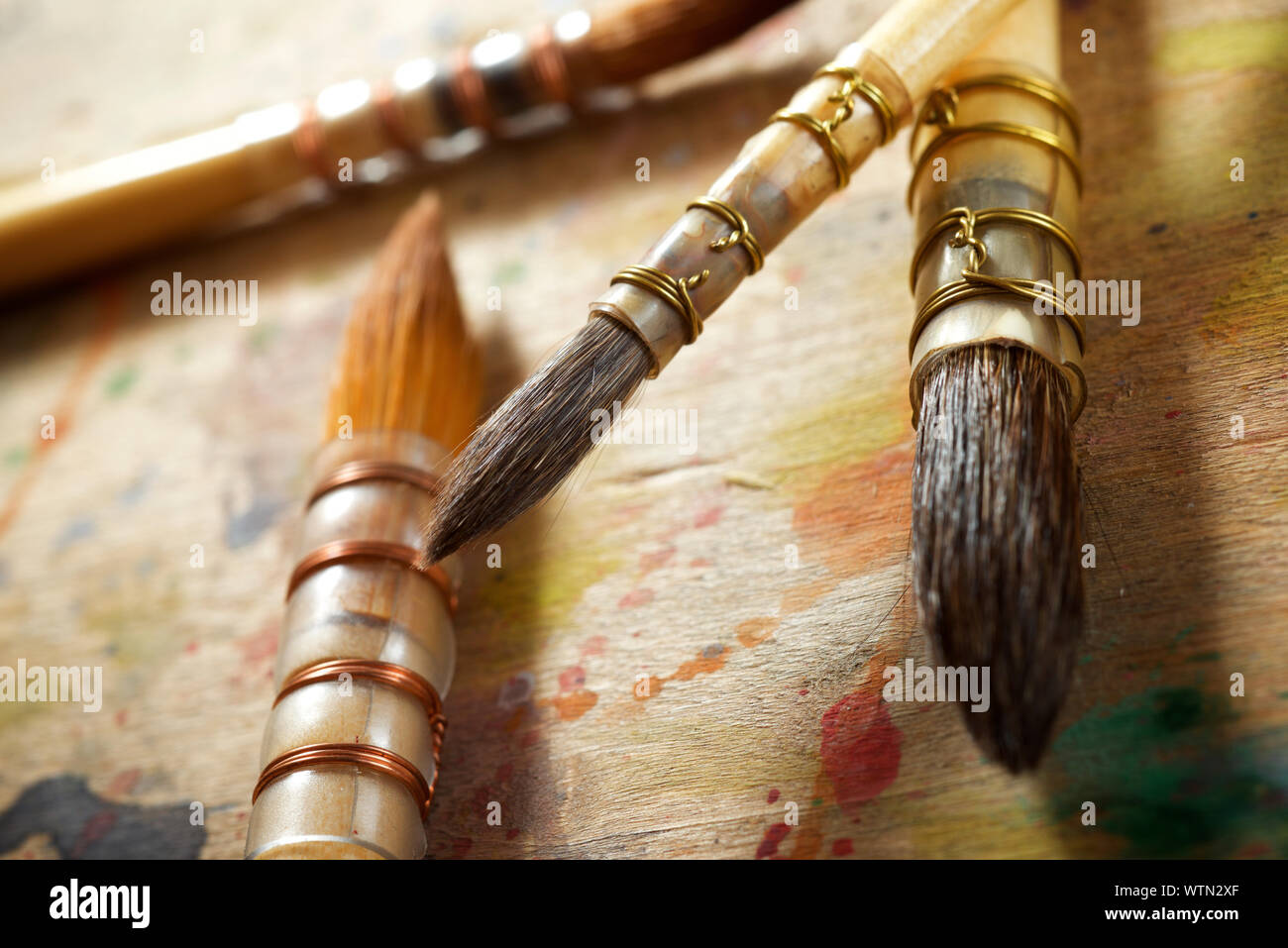 Paintbrushes on a wood table Stock Photo Alamy