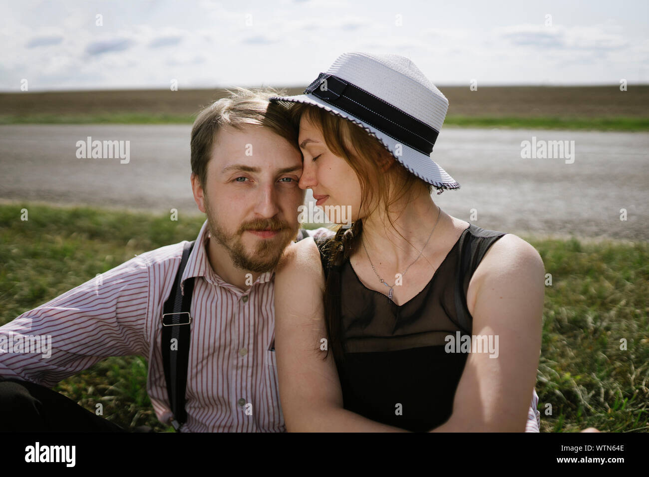 couple in love sitting near the road Stock Photo