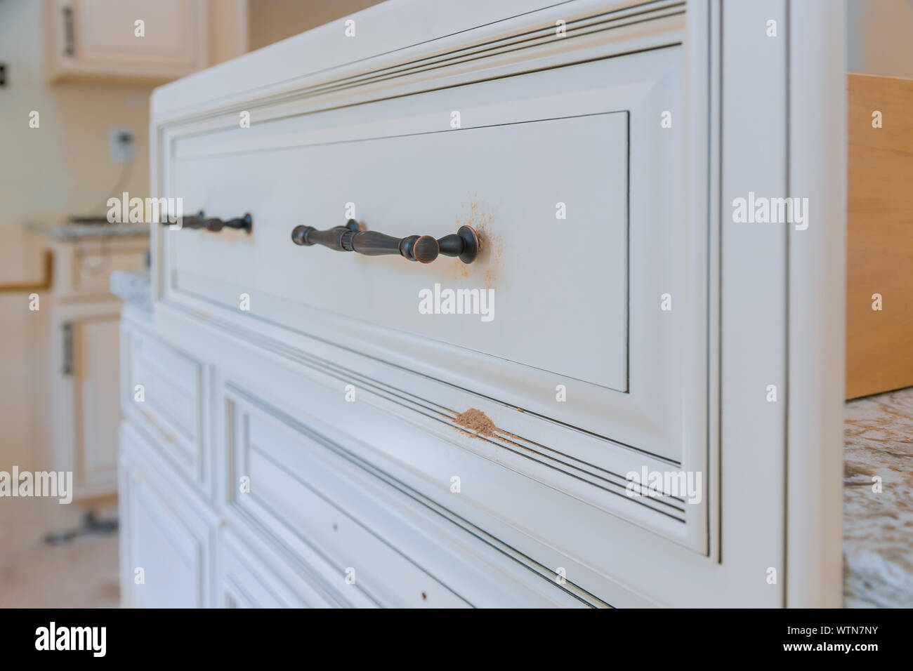 Handle installation drawers in custom kitchen Stock Photo Alamy