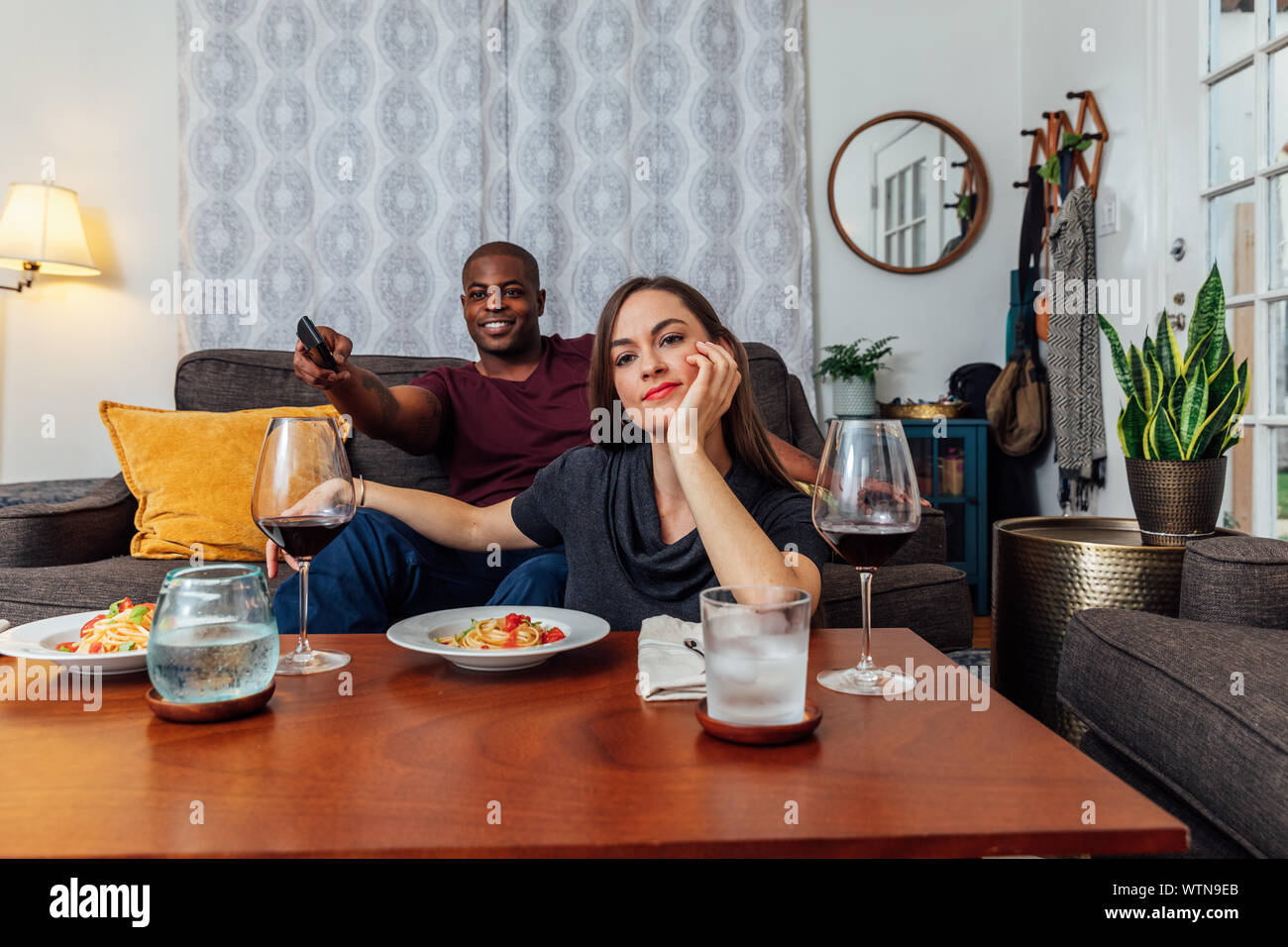 Couple having dinner and watching tv. Stock Photo