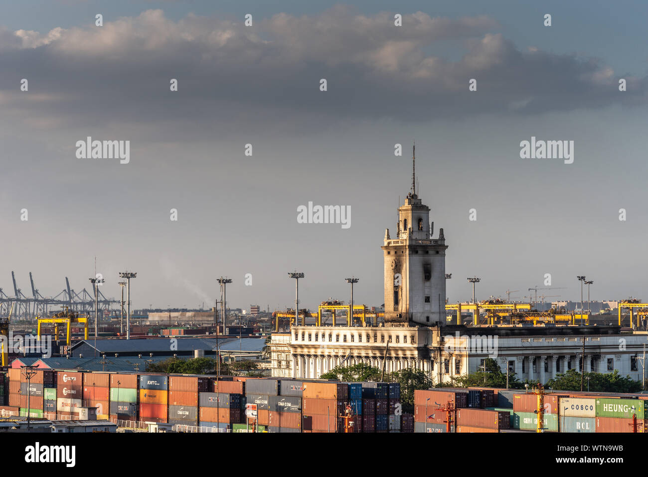 Manila, Philippines - March 5, 2019: South Harbor evening twilight. Bureau  of Customs and Finance office building with tower behind stacks of shipping  Stock Photo - Alamy