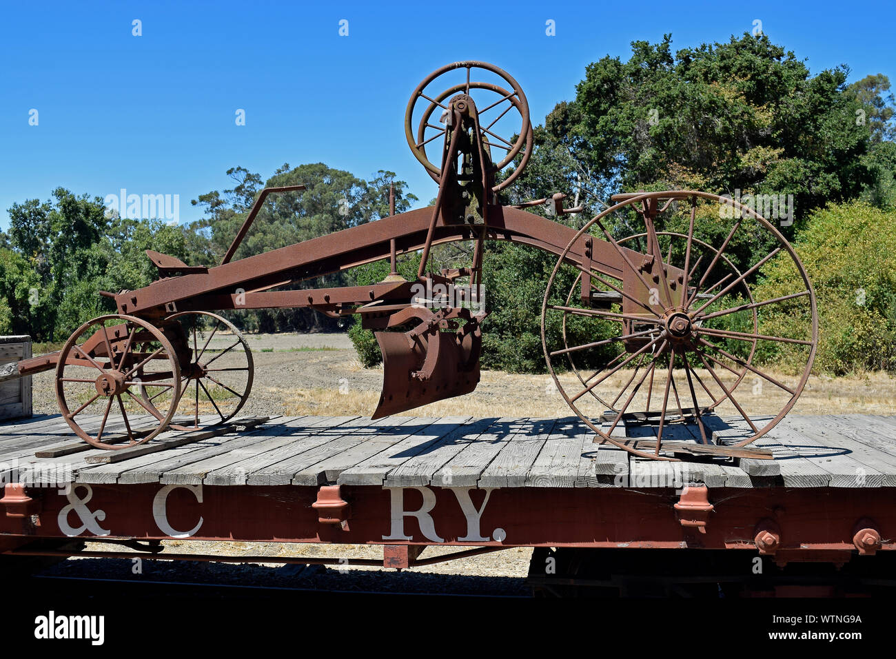 farm equipment on flatbed rail car at  Ardenwood Historic Farm, Fremont, California Stock Photo