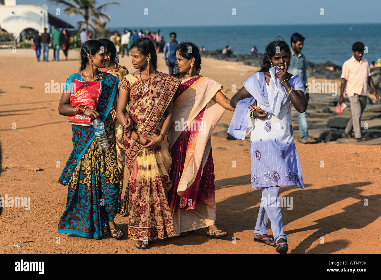 Indian women strolling on the Puducherry beach pomenade. Stock Photo