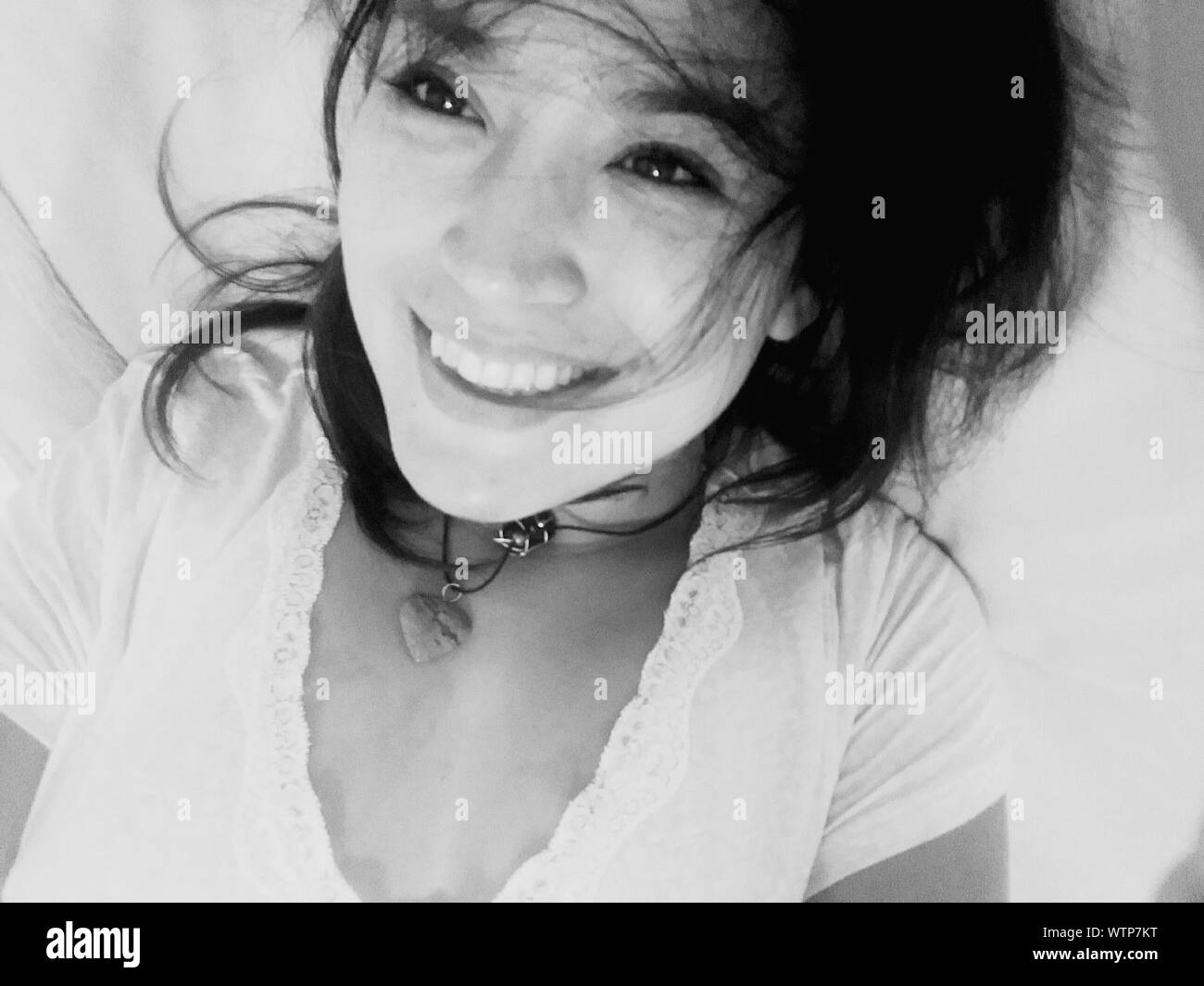 Happy Young Woman Lying Down On Bed Stock Photo Alamy