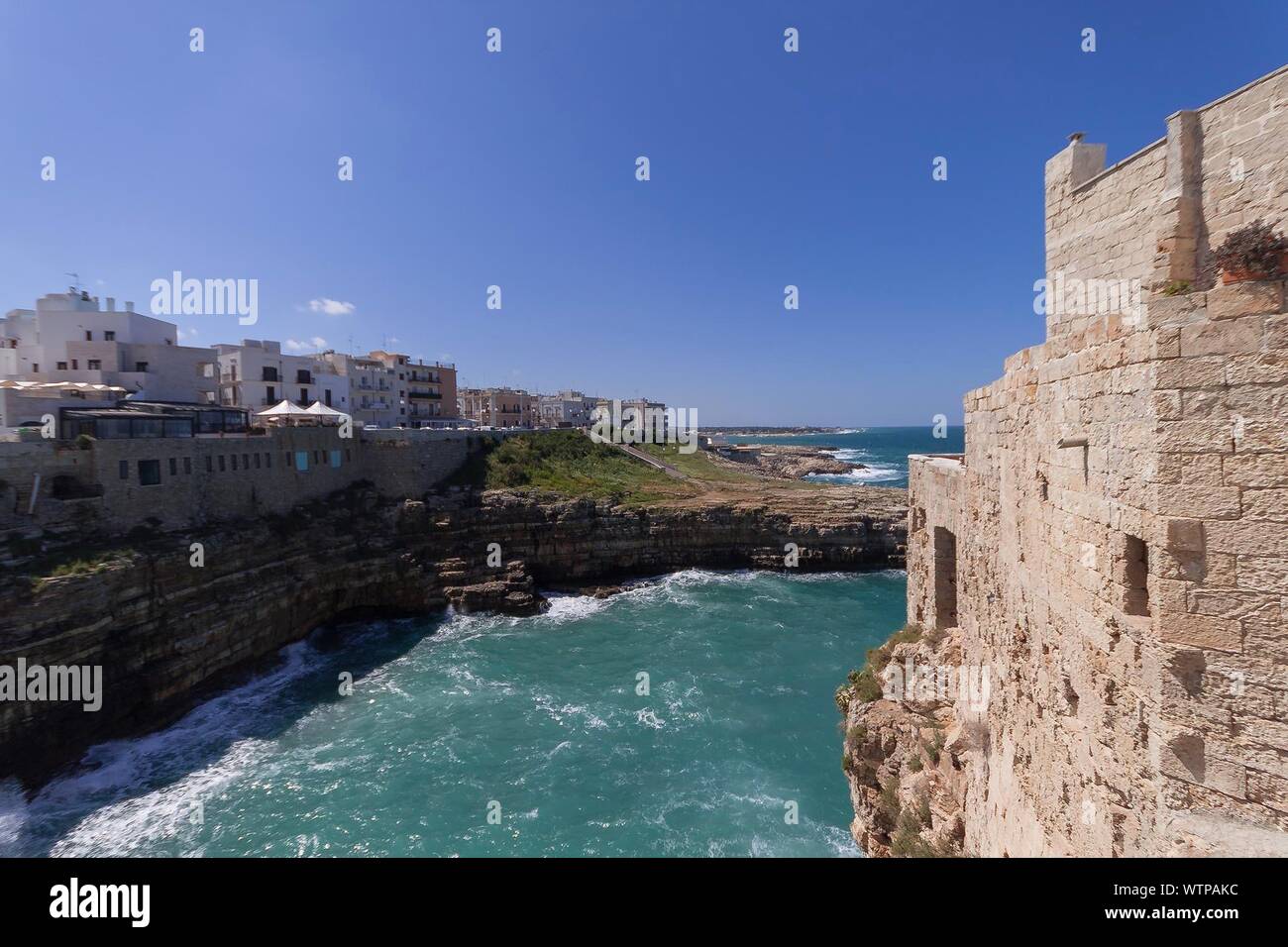 View Of Built Structures Along Calm Blue Sea Stock Photo - Alamy
