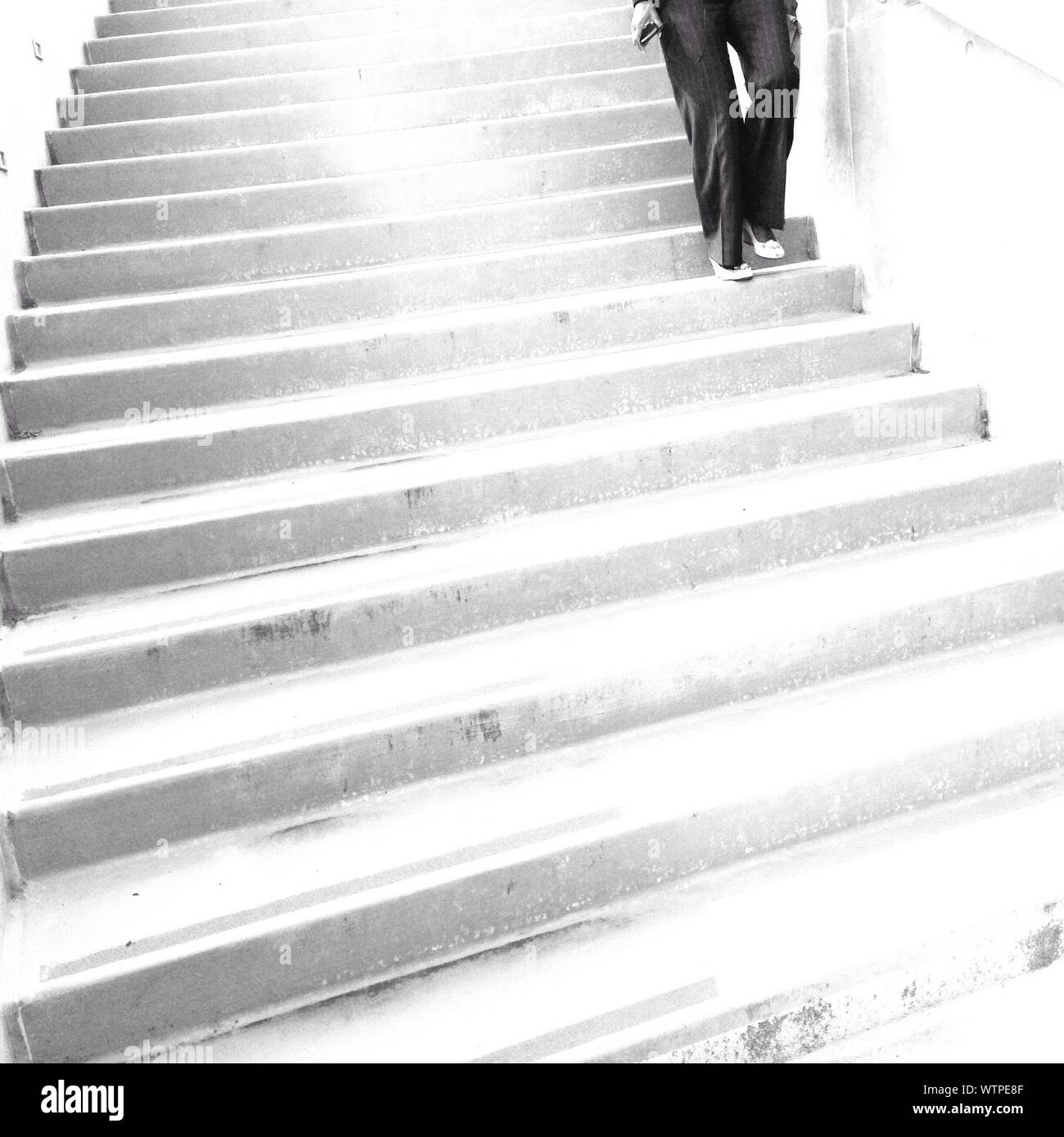Woman Moving Down To Stairs Stock Photo