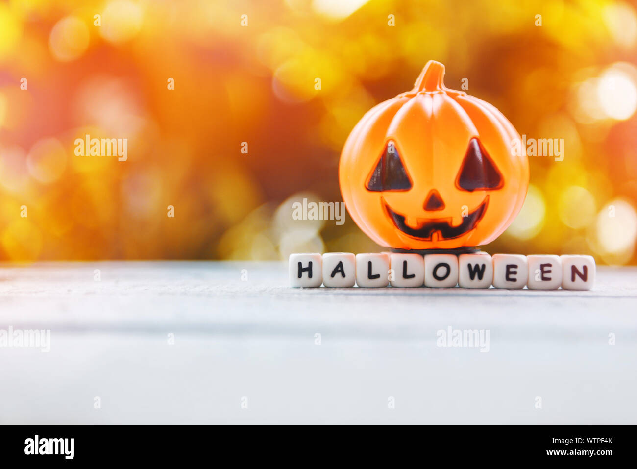 Halloween background decorated holidays festive concept / funny faces jack o lantern pumpkin halloween decorations for party accessories object  on wo Stock Photo