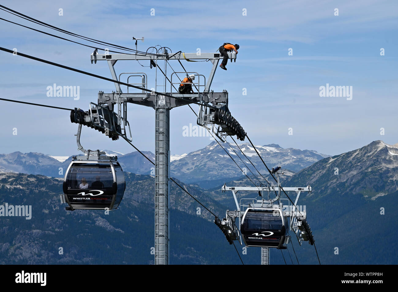 Two men working on ski lift towers, Whistler, B.C Canada. Stock Photo