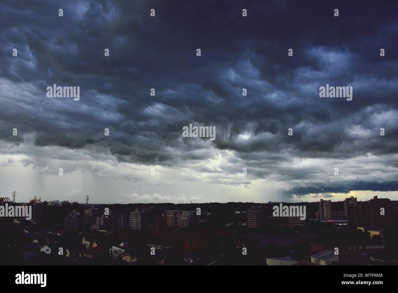 Silhouette City Below Cloudscape Stock Photo