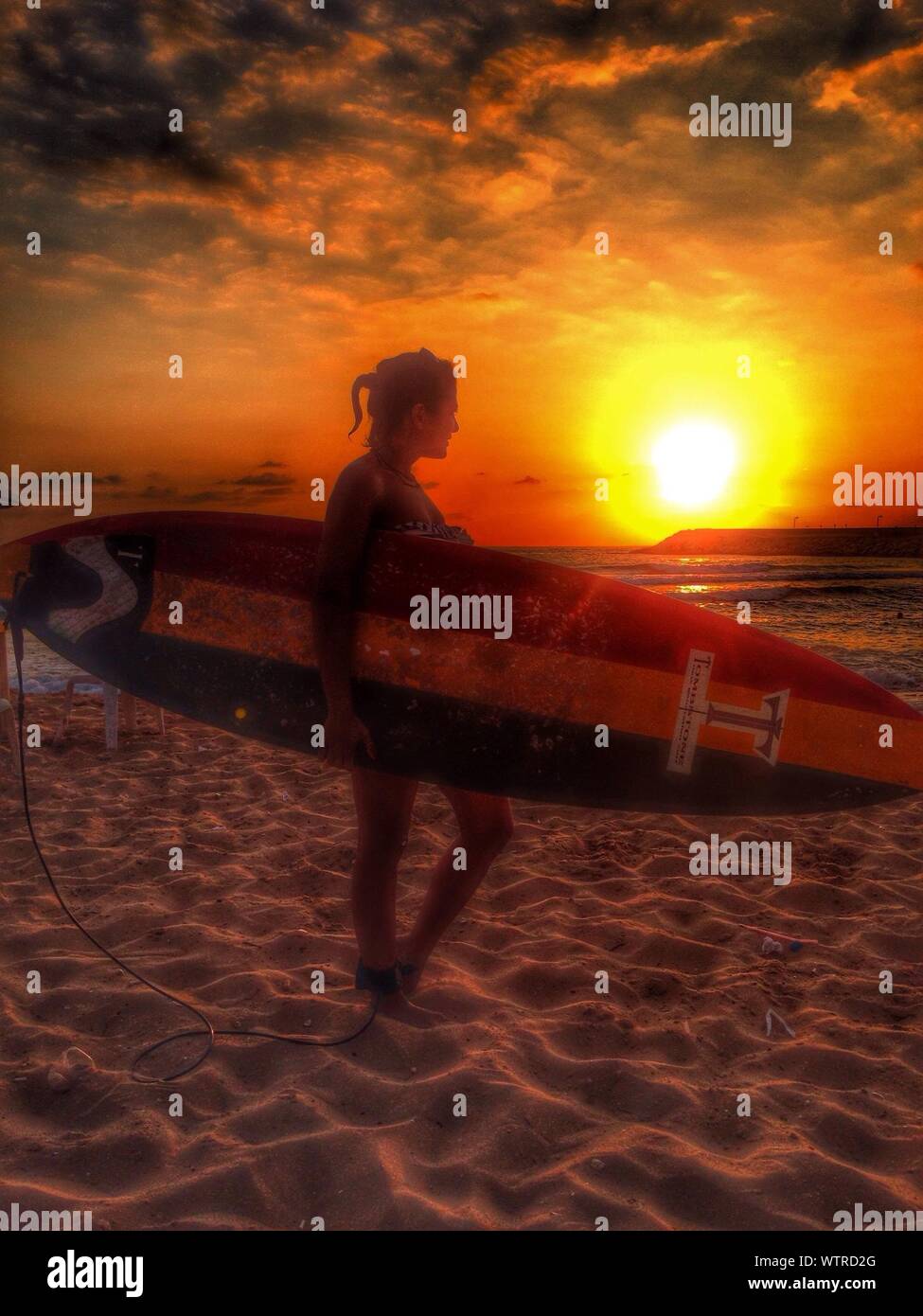Woman holding surfing board hi-res stock photography and images - Alamy