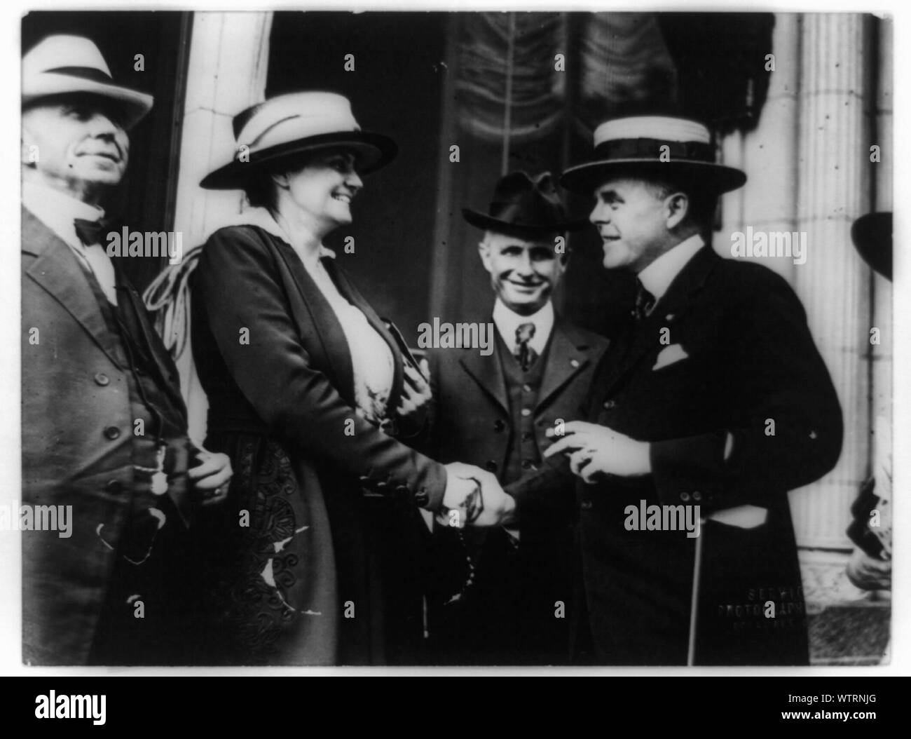 Mrs. James Rector of Columbus, Ohio consulting with W.D. Jameson on the ...