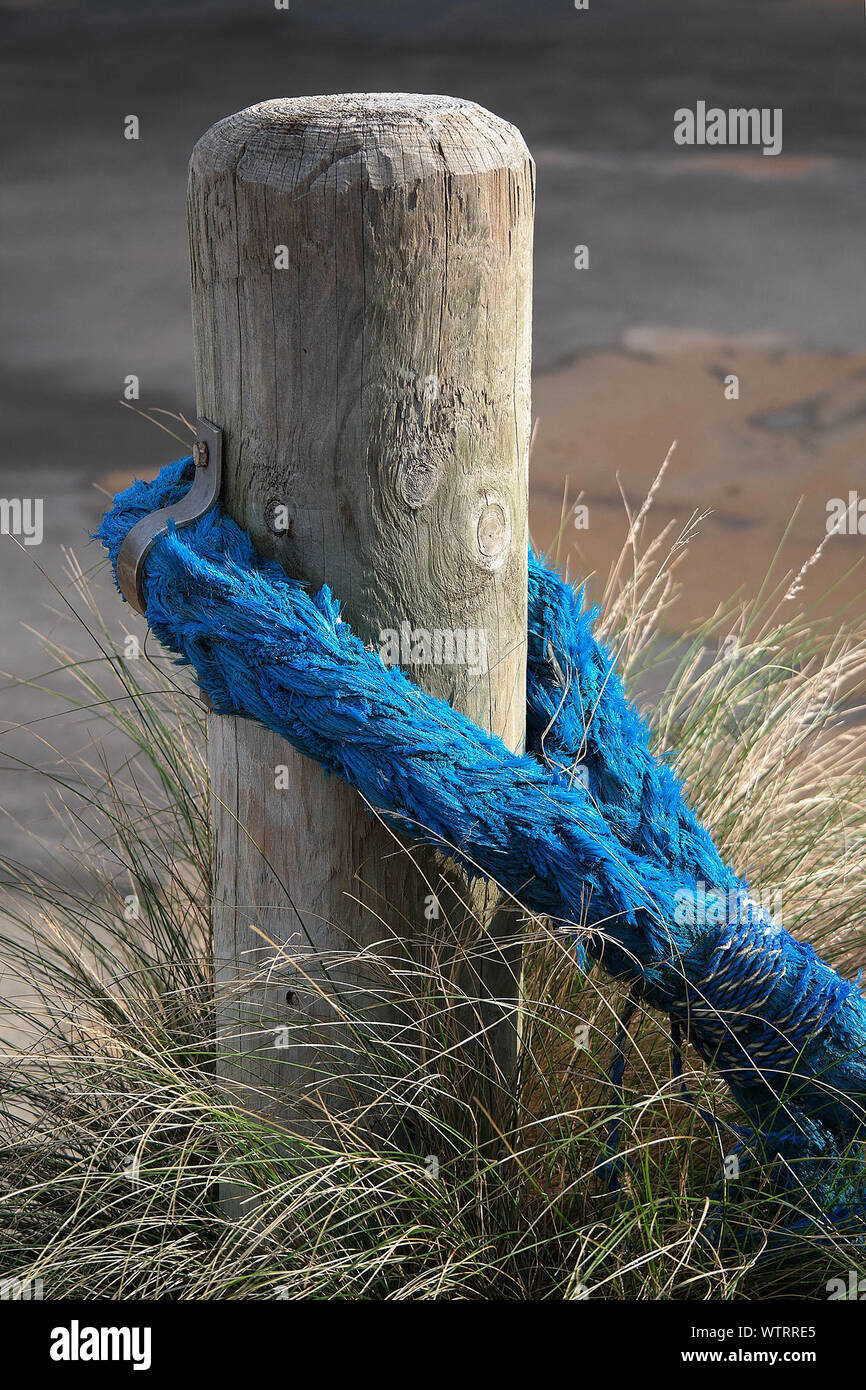 Rope Tied With A Wooden Post Stock Photo