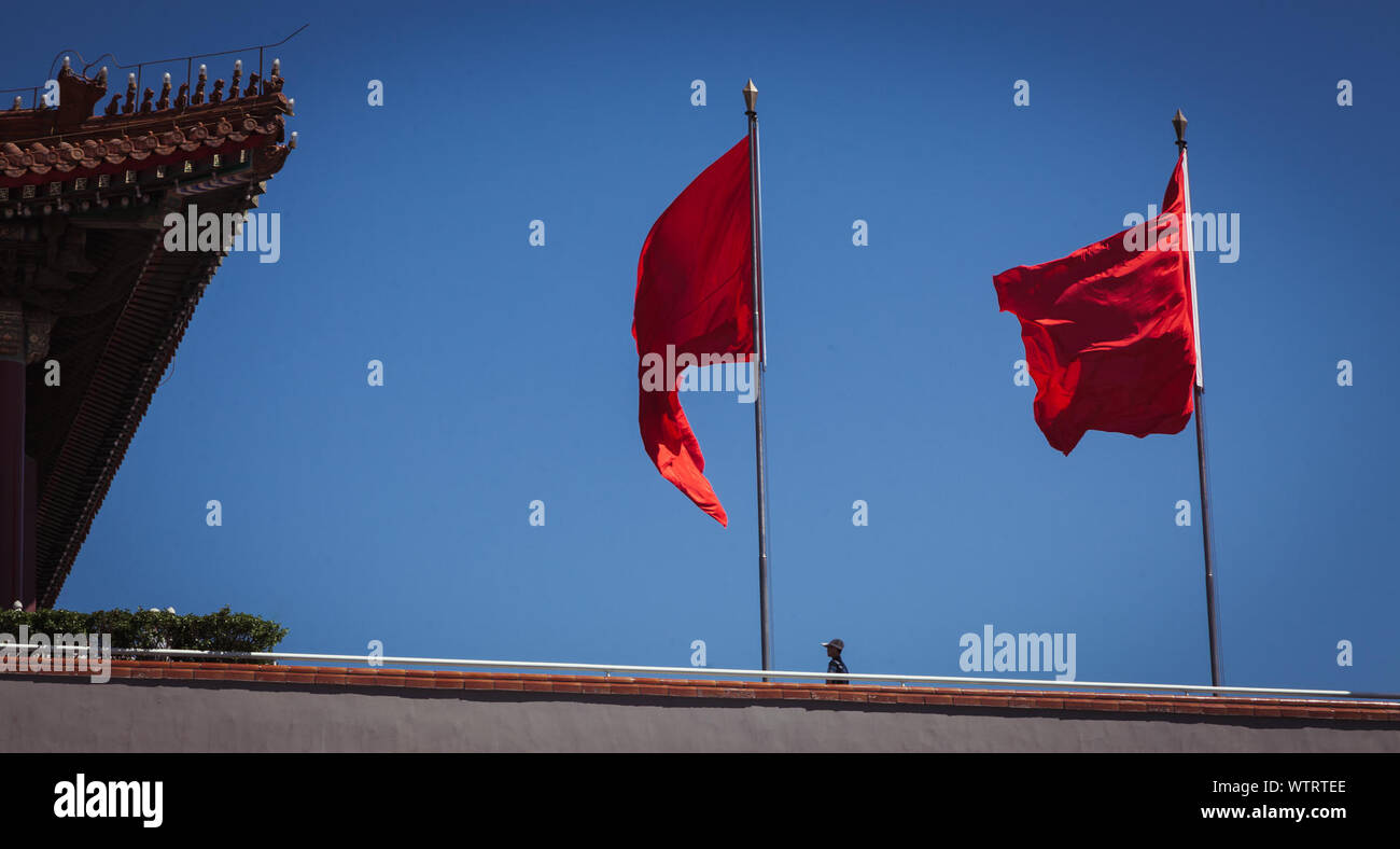 Low Angle View Of Red Flags At Forbidden City Against Clear Blue Sky Stock Photo