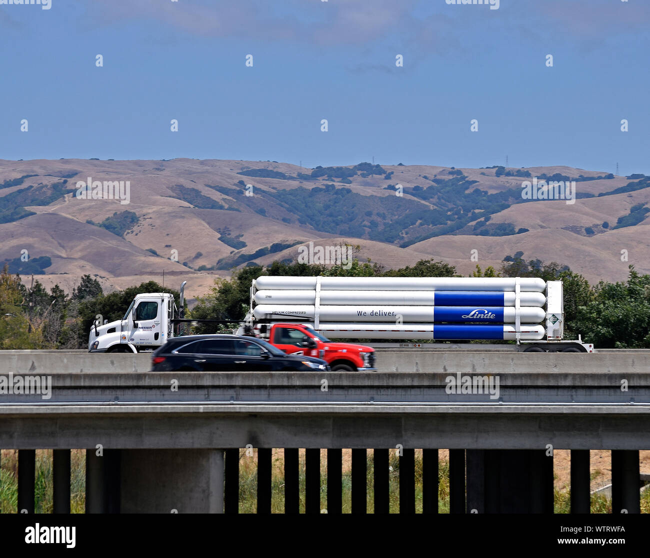 truck transporting Linde helium compressed on 880 freeway overpass over Alameda creek, California Stock Photo