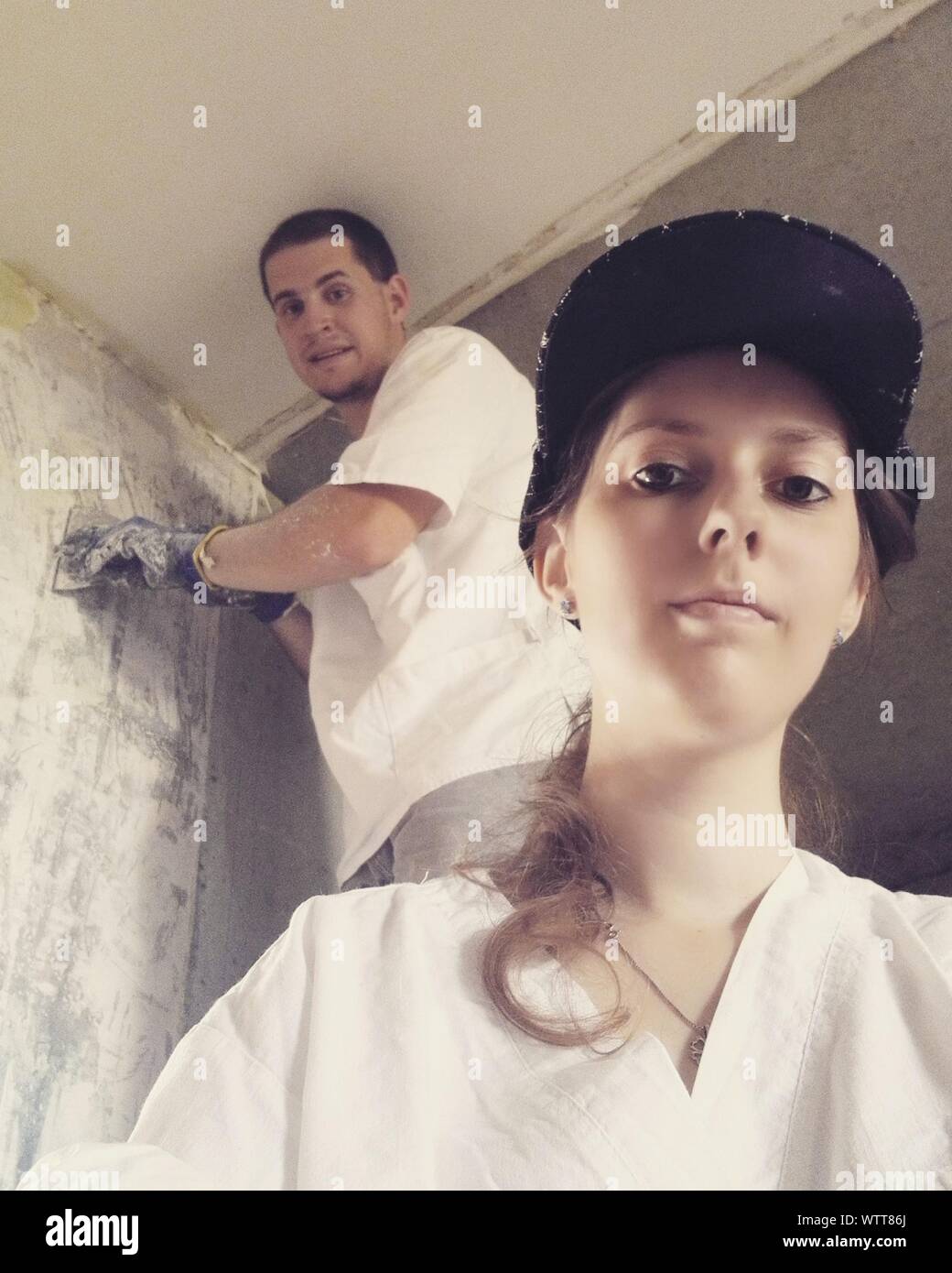 Young Couple Renovating House Stock Photo