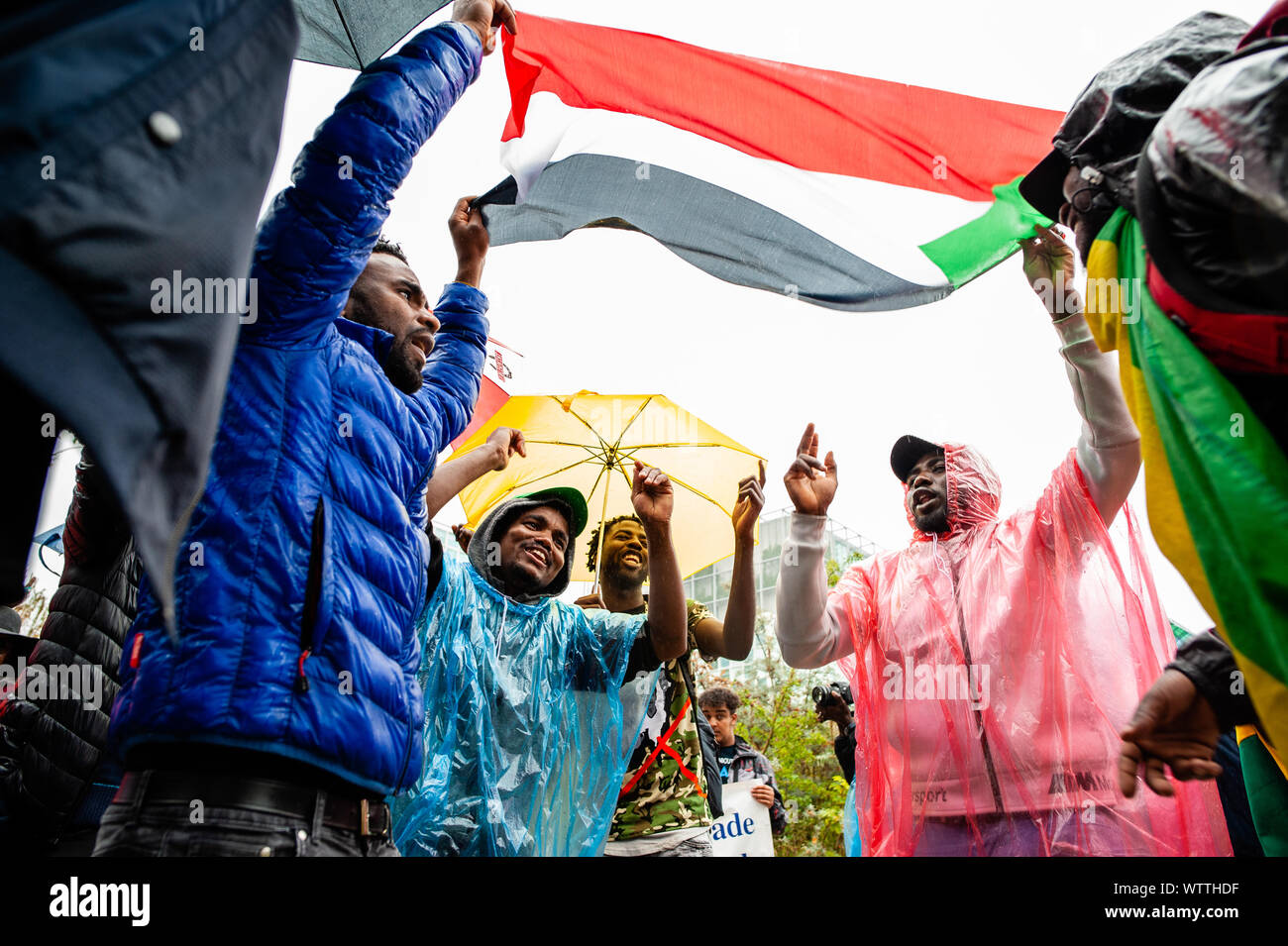 A group of Sudanese people dance below a Sudanese flag during the march.From September 6th to 11th, an international Sudanese march took place starting in London and ending in The Hague after stopping in France and Belgium. On September 11th, the march arrived in front of the International Criminal Court building, situated in The Hague. The march was held in solidarity with the Sudanese revolution and calls for the prosecution of military criminals in Sudan. The march was organized by the Sudanese Initiative Europe. Stock Photo