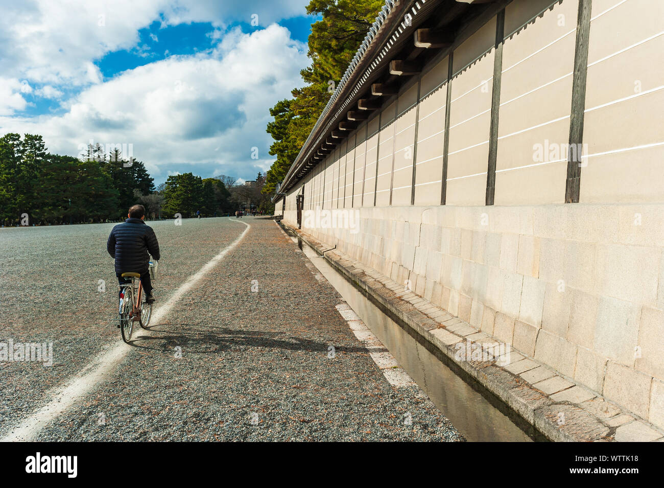 Cycling past the Imperial Palace in Kyoto Stock Photo