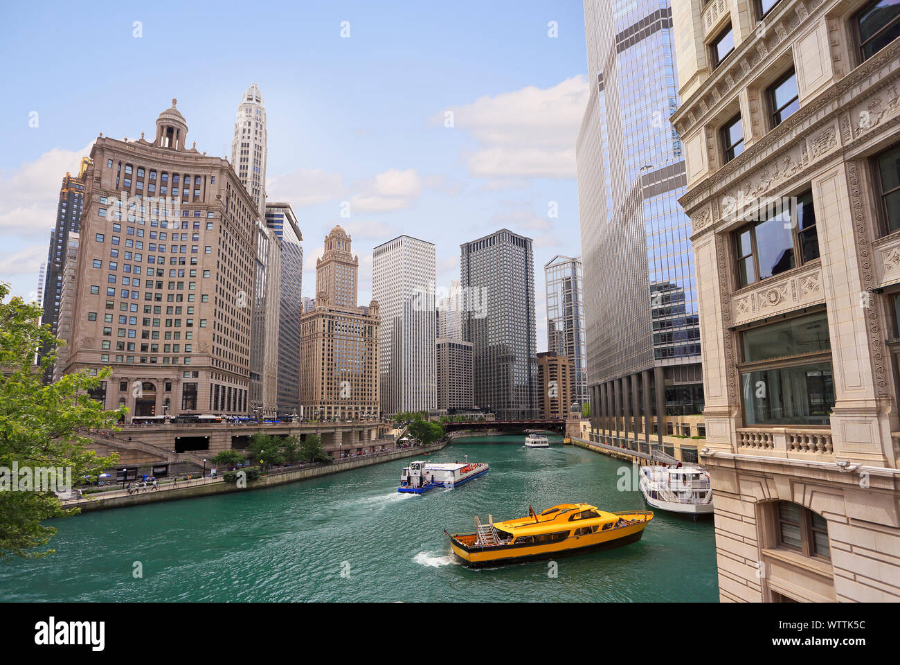 Chicago River with water taxi and boats sailing between the beautiful skyscrapers skyline, Illinois, USA Stock Photo