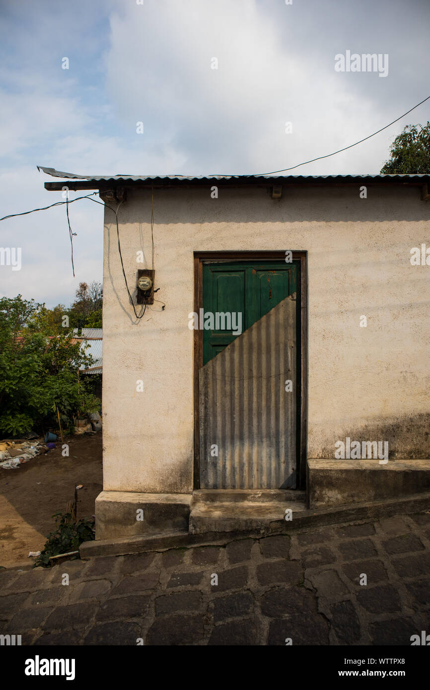 Small Building With Door Of Half Metal And Green Wood In Guatemala