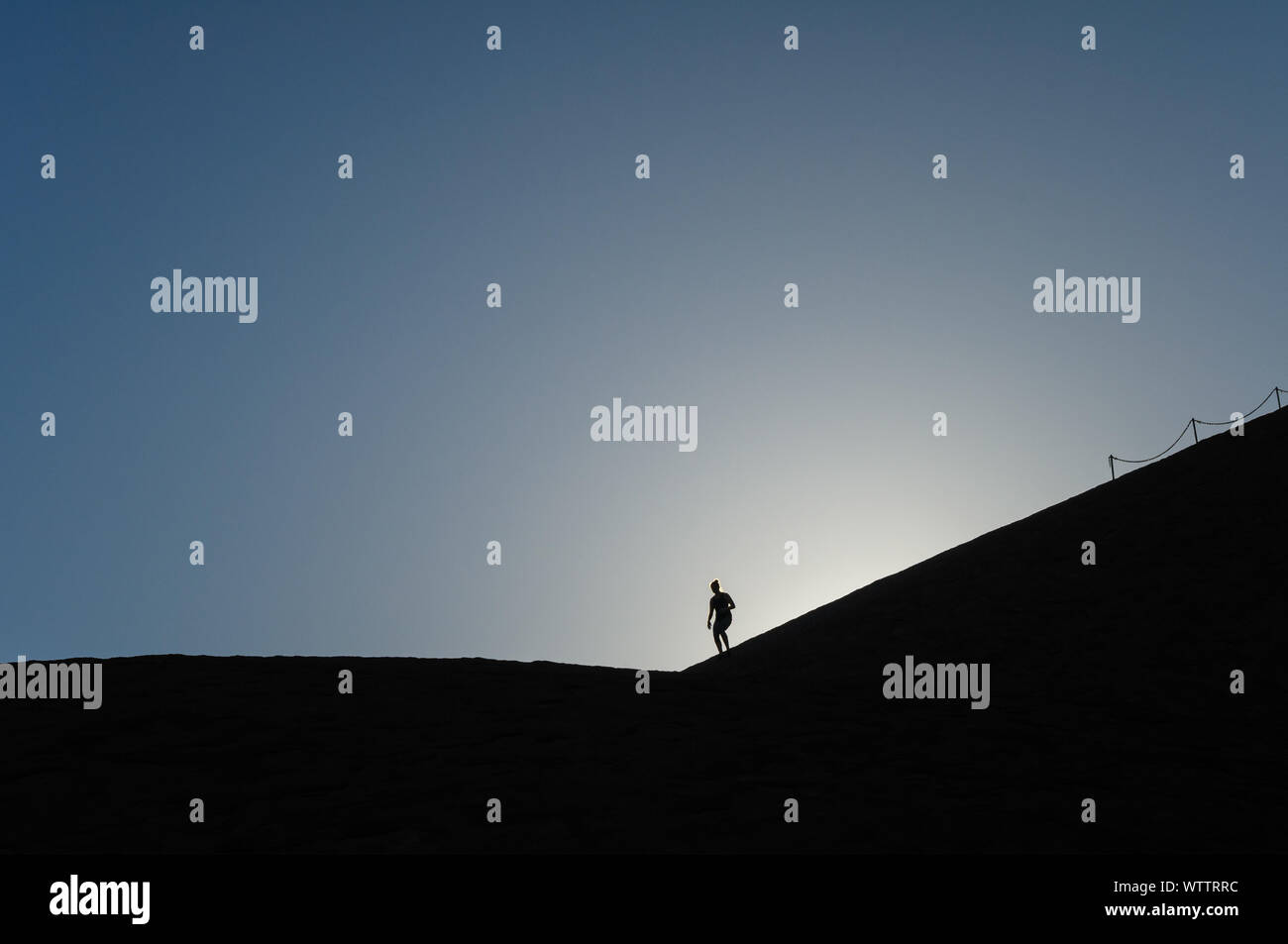 Silhouette on Uluru Stock Photo