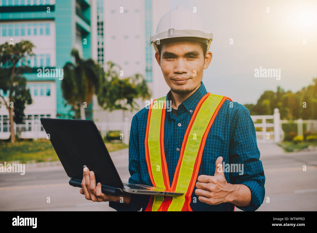 Engineer holding computer working on side technology Building