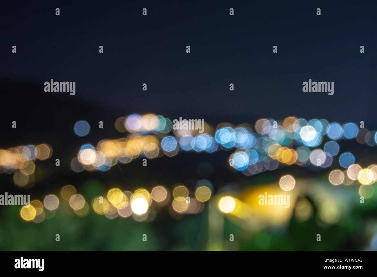 Blurred lights of the homes on the mountain used as a background. Stock Photo