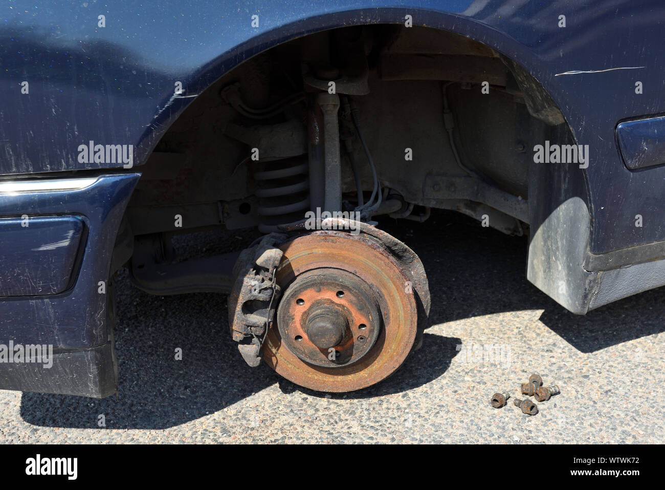 Old, Rusty Front Brake discs with caliper and brake pads in the car Stock Photo