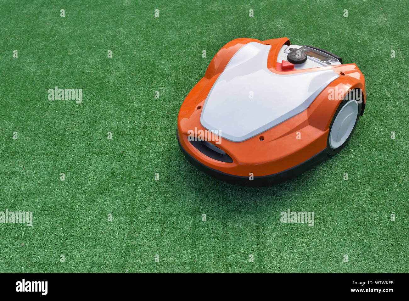 Robotic Lawn Mower on green background Stock Photo