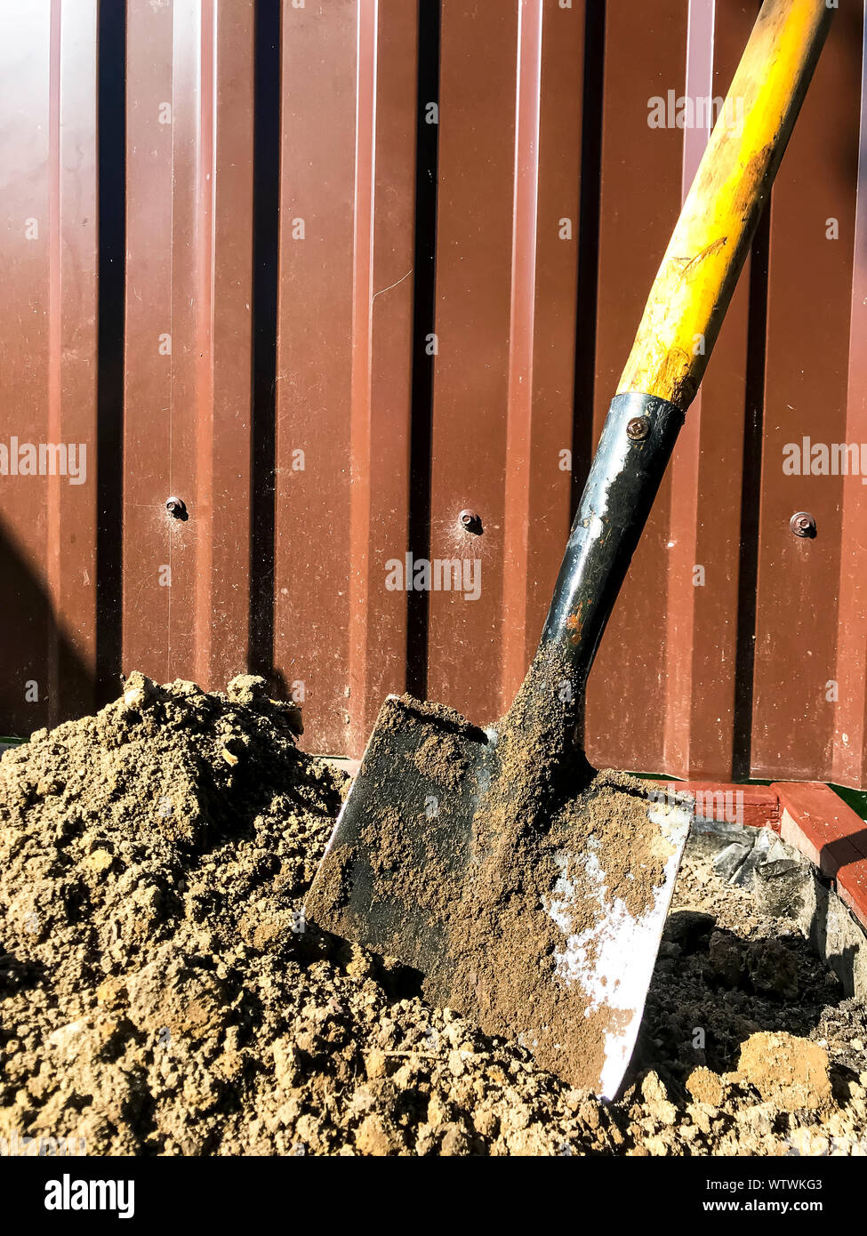 Dirty shovel in black earth, gardening job Stock Photo