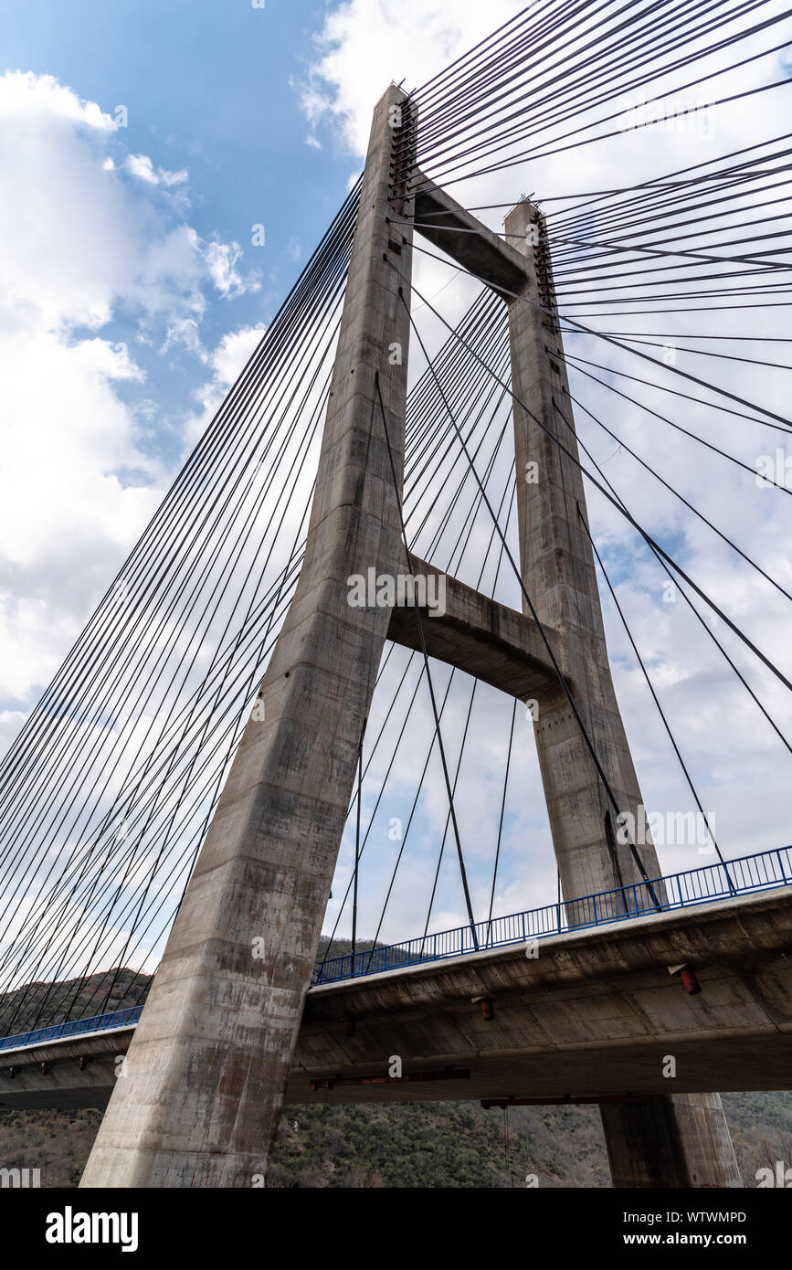 Modern suspension bridge. Detail of tower and steel cables. Barrios de Luna, Castile and Leon, Spain. Stock Photo