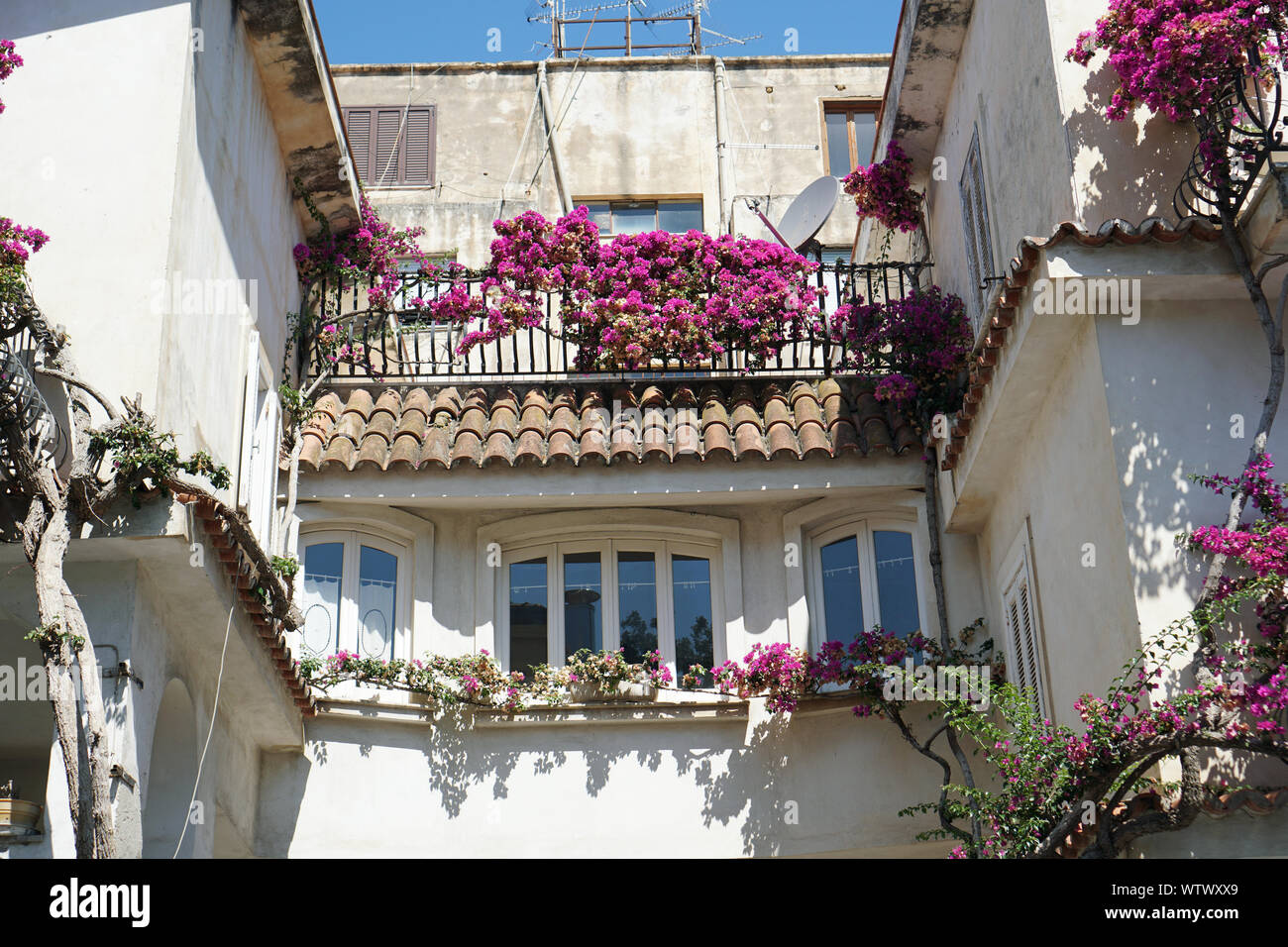 Typical Italian flowered balconies of an old house in Tropea, Calabria, Italy in August 2019 Stock Photo