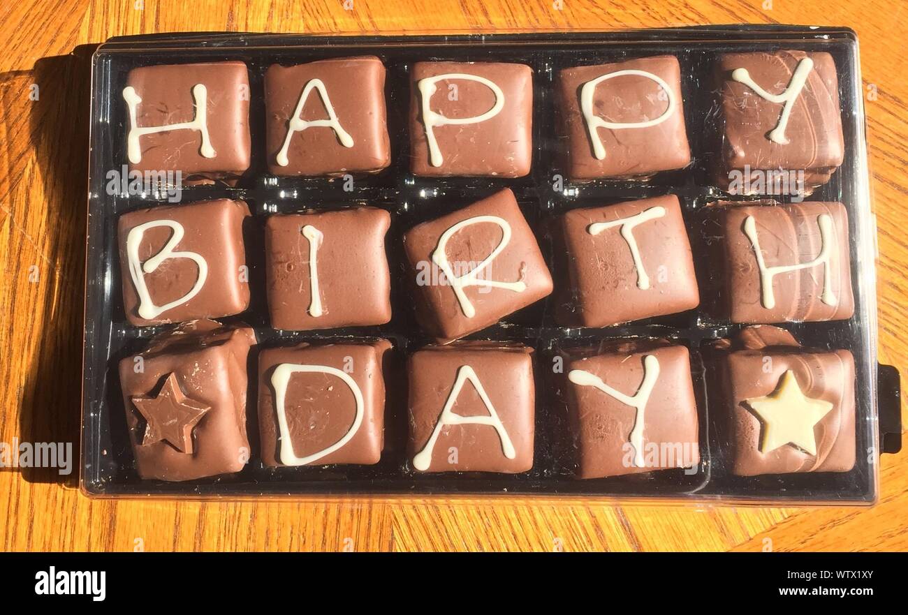 Download High Angle View Of Happy Birthday Text On Chocolates In Tray On Table Stock Photo Alamy PSD Mockup Templates