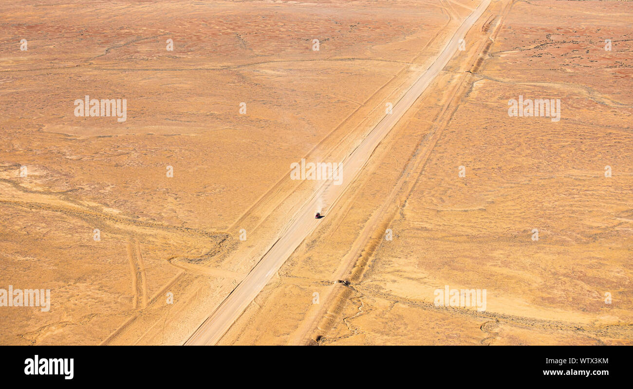 An aerial shot of a car making its way down the Oodandatta Track, South Australia Stock Photo