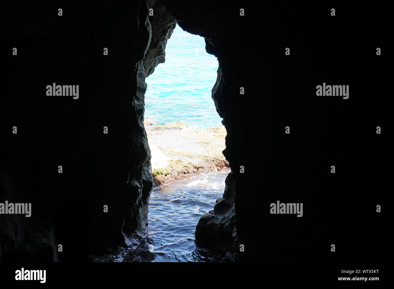 The view inside of a natural sea cave in Tropea, Calabria, Italy in august 2019 with sea at the back Stock Photo